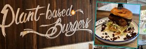 Image of wall sign at Soul Burger restaurant saying plant-based burgers, inset with a picture of a plant-based chicken burger.