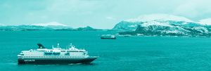 Image of tourist ship with Antarctica in the background.